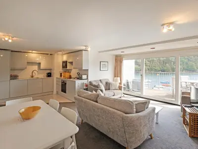 a living room with a couch and a table at Middle Deck in Fowey