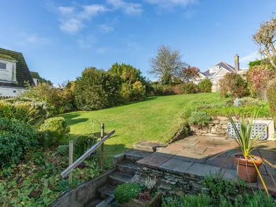 a garden with stairs and a grassy yard at Bosula in Fowey