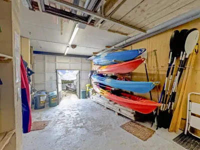 a group of kayaks are hanging on a wall at Tarquins in Fowey