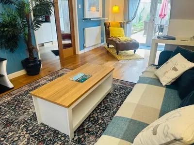 a living room with a couch and a coffee table at Beach Road- short walk to Charlestown, Carlyon Bay & coastal paths- dog friendly in Carlyon Bay