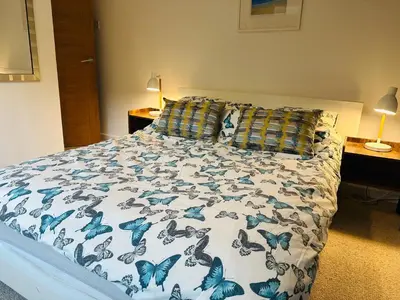 a bedroom with a bed with blue butterflies on it at Beach Road- short walk to Charlestown, Carlyon Bay & coastal paths- dog friendly in Carlyon Bay