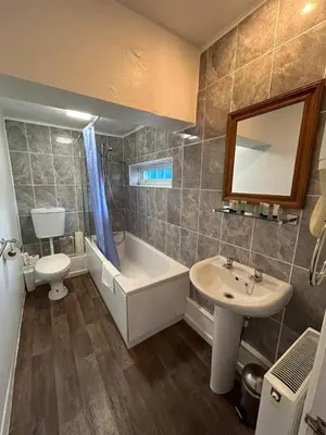 a bathroom with a sink and a tub and a toilet at Trengilly Wartha Inn in Constantine