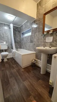 a bathroom with a tub and a sink and a toilet at Trengilly Wartha Inn in Constantine
