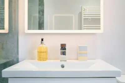a white bathroom sink with a bottle of soap at Finest Retreats - Luxury Holiday Let in Porthleven, Sleeping 2 in Porthleven