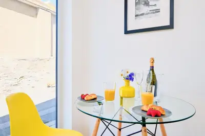 a glass table with two glasses of orange juice at Finest Retreats - Luxury Holiday Let in Porthleven, Sleeping 2 in Porthleven