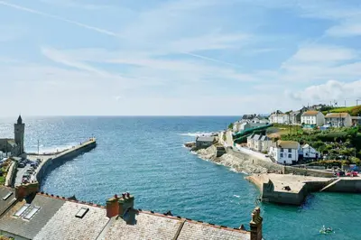 a view of the ocean with houses and a pier at Finest Retreats - Luxury Holiday Let in Porthleven, Sleeping 2 in Porthleven