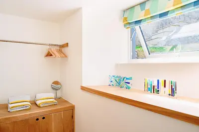 a room with a window and a wooden shelf at Finest Retreats - Luxury Holiday Let in Porthleven, Sleeping 2 in Porthleven