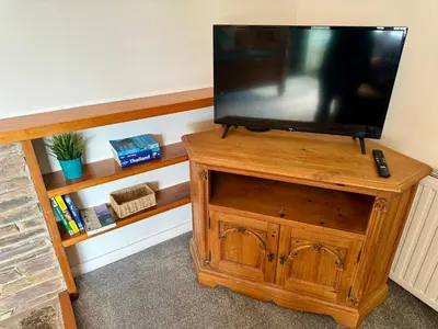 a television on a wooden stand in a room at Travellers Rest in Launceston