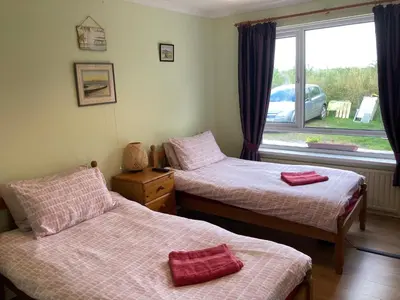 two beds in a room with a window at Travellers Rest in Launceston