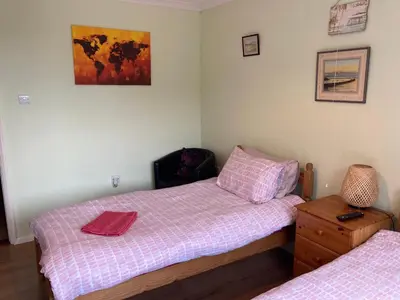 a twin bedroom with two beds and a table at Travellers Rest in Launceston