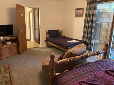 a bedroom with a bed and a tv and a window at Travellers Rest in Launceston