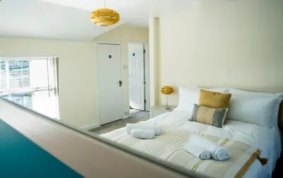 a bedroom with a bed with towels on it at Victoria Inn in Penzance