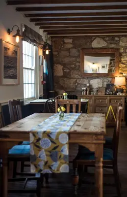 a table with a table cloth on it in a kitchen at Victoria Inn in Penzance