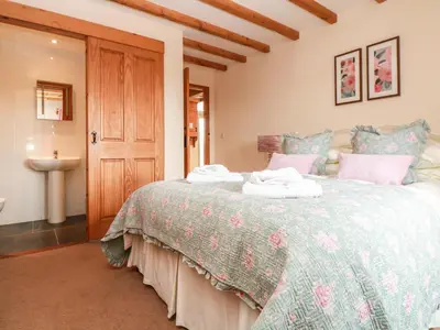 a bedroom with a bed and a sink at Ash Cottage in Truro