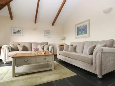 a living room with two couches and a coffee table at Ash Cottage in Truro