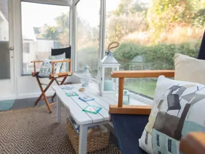 a living room with a bench and a table at Kilcarreg in Wadebridge