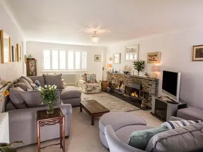 a living room with couches and a fire place at Kilcarreg in Wadebridge