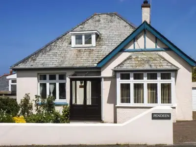 a large white house with a black door at Pendeen in Wadebridge