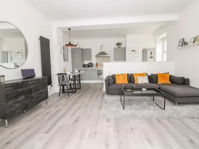 a living room with a couch and a table at Sea Breeze in Marazion