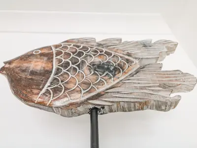 a fish carved out of wood on a stick at Sea Breeze in Marazion
