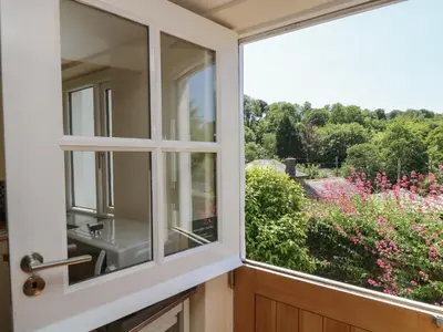 a window with a view of a garden at Little Hamlin in Callington