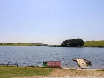 a large lake with a dock in the water at Little Hamlin in Callington