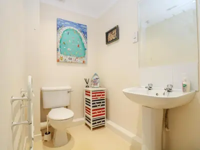 a bathroom with a white toilet and a sink at Fox's Walk in Falmouth