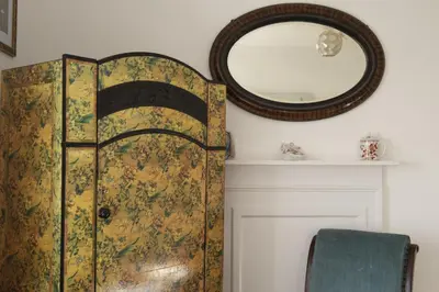 a dressing room with a door and a mirror at Trevara, Marazion in Marazion
