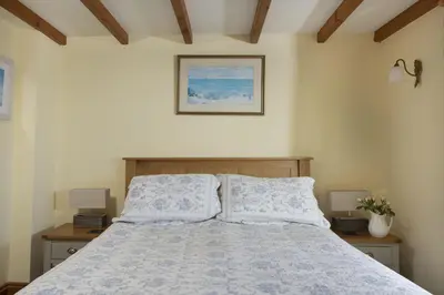 a bedroom with a bed with two pillows at Little Trevara, Marazion in Marazion