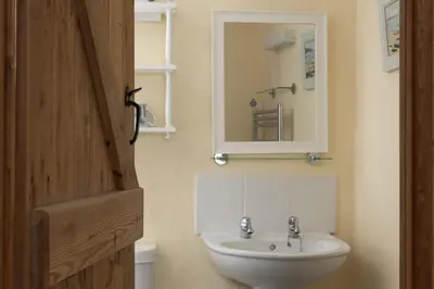 a bathroom with a sink and a mirror at Little Trevara, Marazion in Marazion