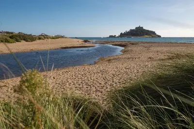 a sandy beach with a body of water at Little Trevara, Marazion in Marazion