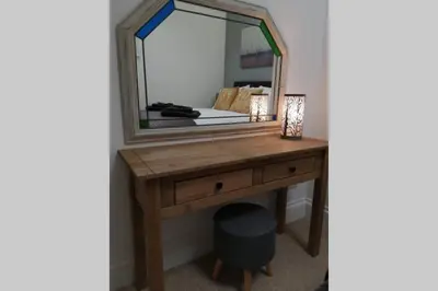 a dressing table with a large mirror on it at Stunning cosy barn in peaceful rural Cornwall in Truro