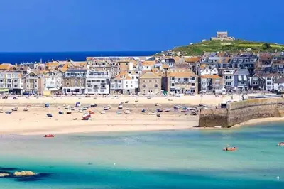 a beach with a group of people on the sand at Stunning cosy barn in peaceful rural Cornwall in Truro