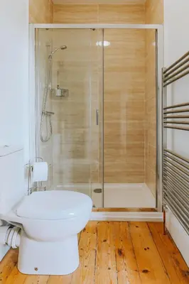 a bathroom with a toilet and a glass shower at Ivy House Cornwall B&B in St Austell