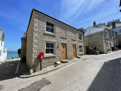 a stone building on the side of a street at Lews Lookout in St Ives