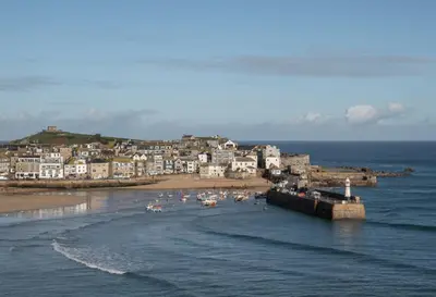 a group of people on a beach near the ocean at Stylish Two Bedroom Cottage - In Town Centre in St Ives
