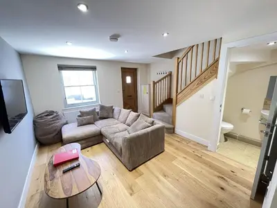 a living room with a couch and a table at Harrys Hideout in St Ives