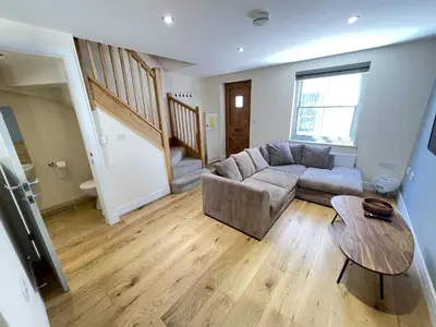 a living room with a couch and a table at Rosies Retreat in St Ives