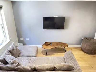 a living room with a couch and a coffee table at Rosies Retreat in St Ives