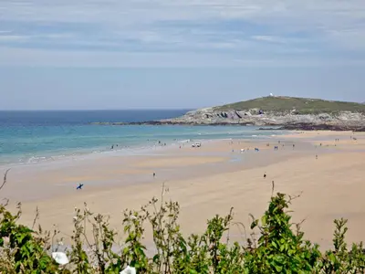 a group of people on a beach near the ocean at Apartment 8 in Newquay