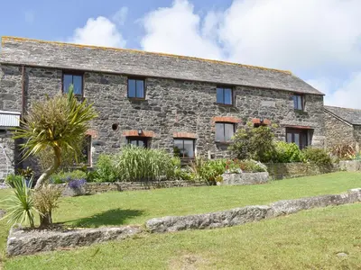 an old stone house with a garden in front of it at Haywain - Uk12084 in Saint Endellion