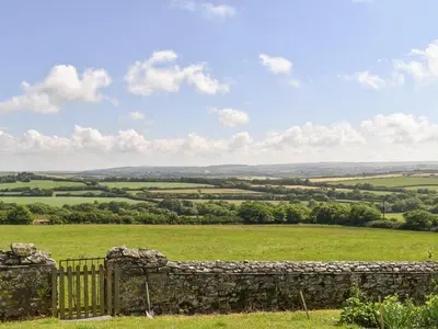 a stone wall in a field with a view at Haywain - Uk12084 in Saint Endellion