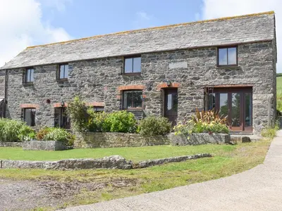 a stone house with windows and plants in front of it at Haywain - Uk12084 in Saint Endellion
