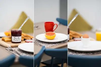 a table with plates of food and a cup of coffee at Harbour Moorings in St Ives