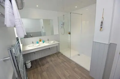 a bathroom with a glass shower and a sink at Mevagissey Bay Hotel in Mevagissey