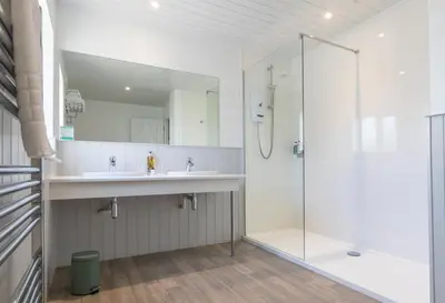 a bathroom with a sink and a shower at Mevagissey Bay Hotel in Mevagissey