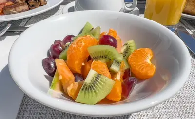 a white bowl filled with fruit on a table at Mevagissey Bay Hotel in Mevagissey