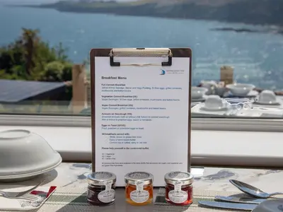 a menu on a table in front of a window at Mevagissey Bay Hotel in Mevagissey