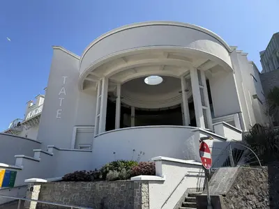 a white house with a stop sign in front of it at Sixpence Cottage, a few steps from the harbour! in St Ives