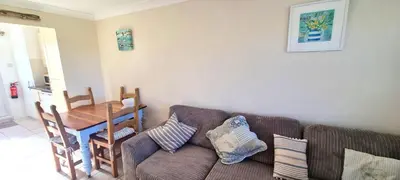 a living room with a couch and a table at Ocean's Eddge, Perranporth in Perranporth